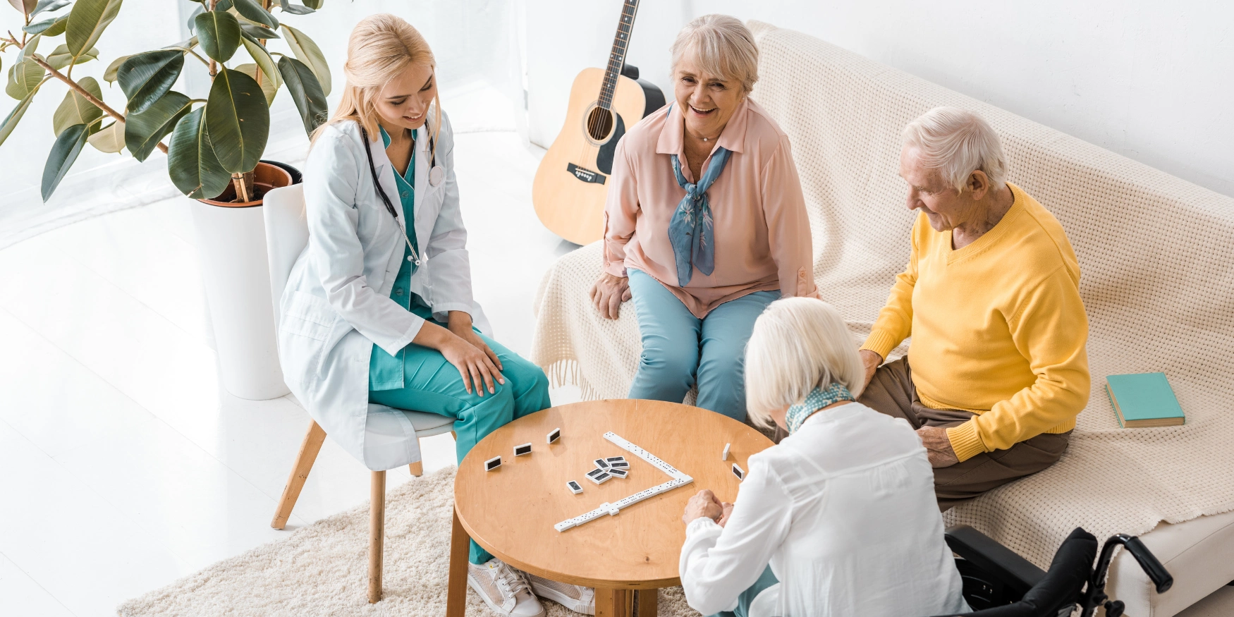 Group of elderly residents socializing together inside a warm, supportive senior home.